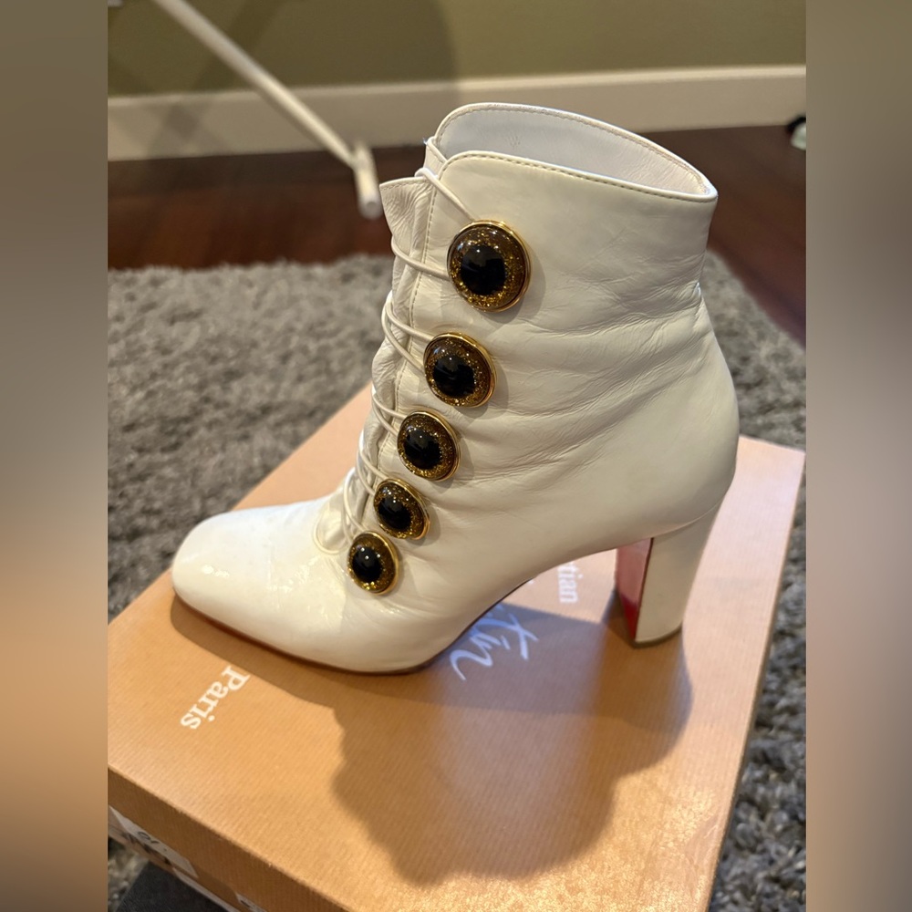 Christian Louboutin Elegant White Ankle Boots with Gold Accents.